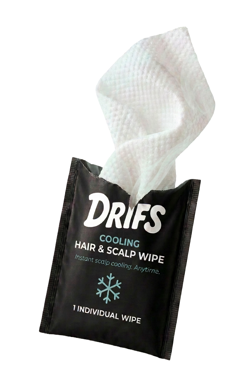 A torn-open DRIFS cooling hair and scalp wipe sachet with the textured wipe emerging
